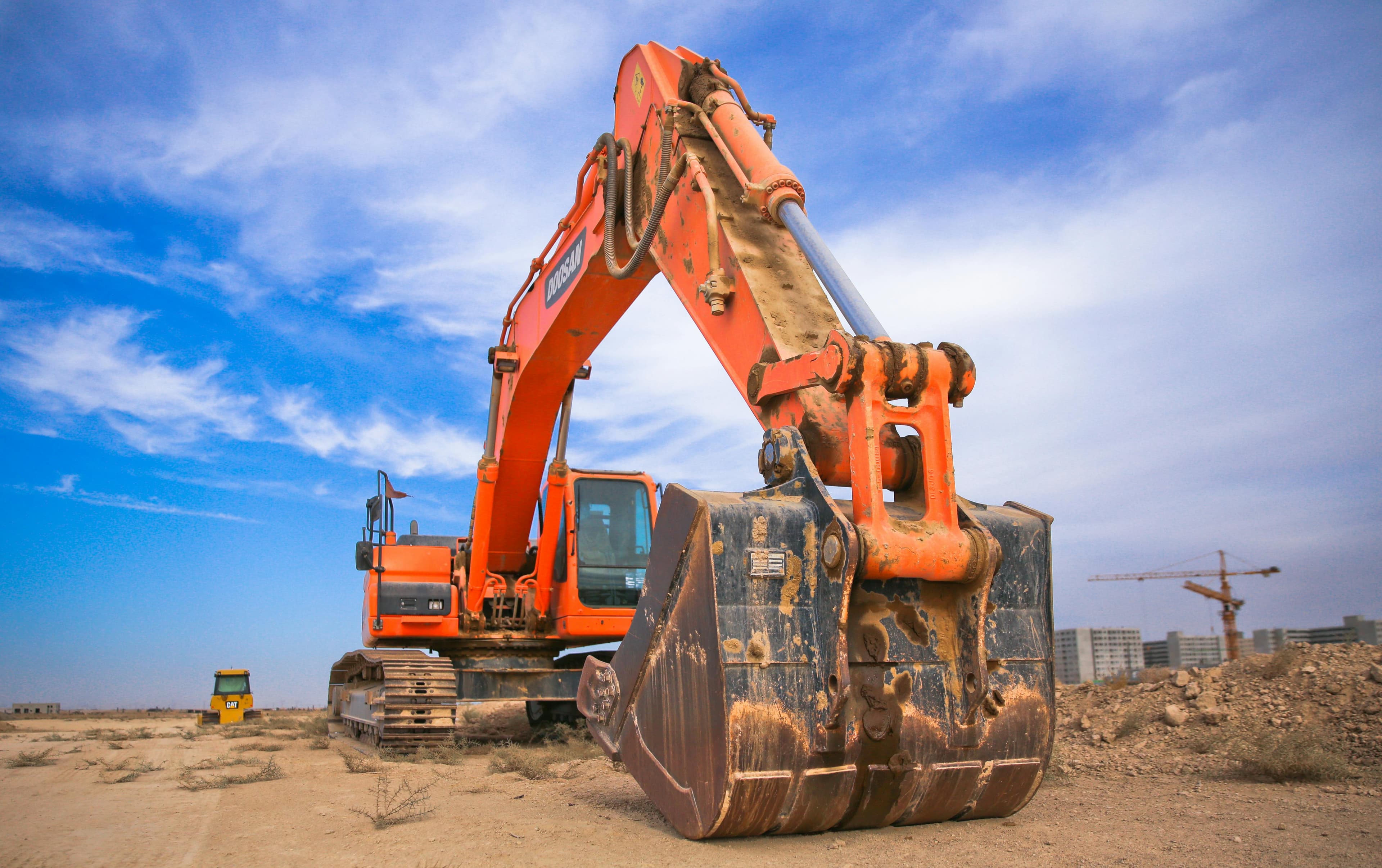 Heavy excavator loading raw stone into the crusher